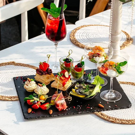 Colorful cocktails and gourmet appetizers display.